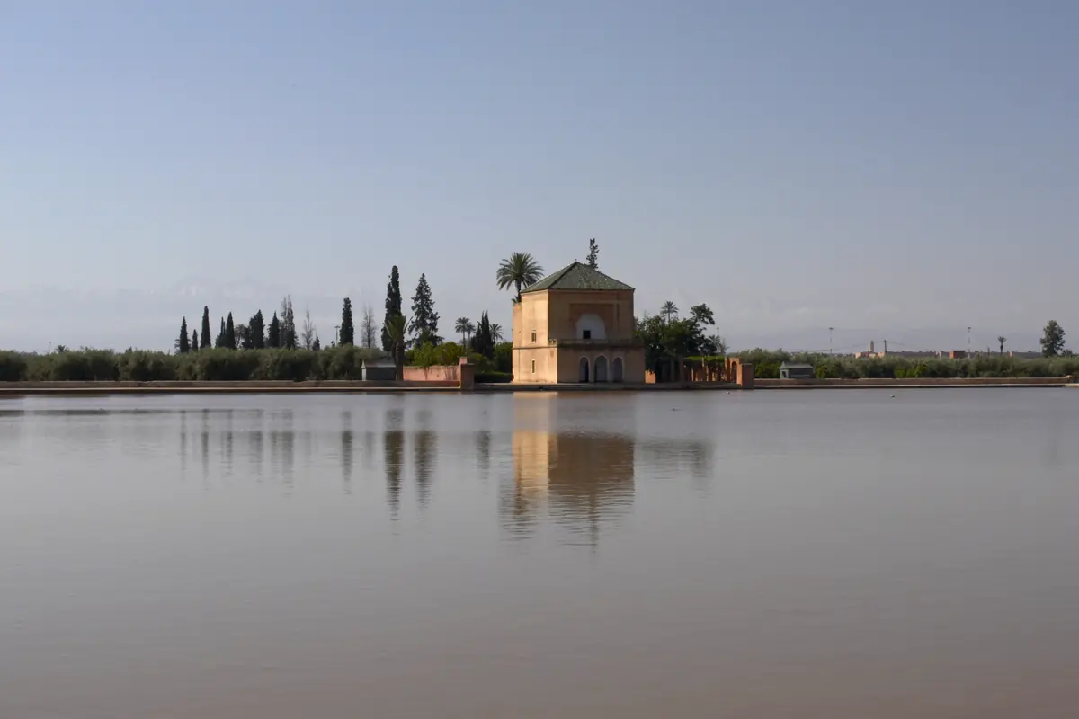 Menara pavilion on the far side of its great pool, among trees