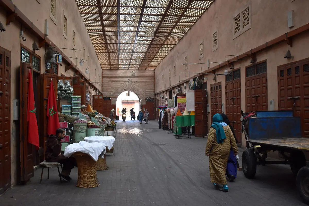 Street with a latticed roof and shops on both sides in the Mellah